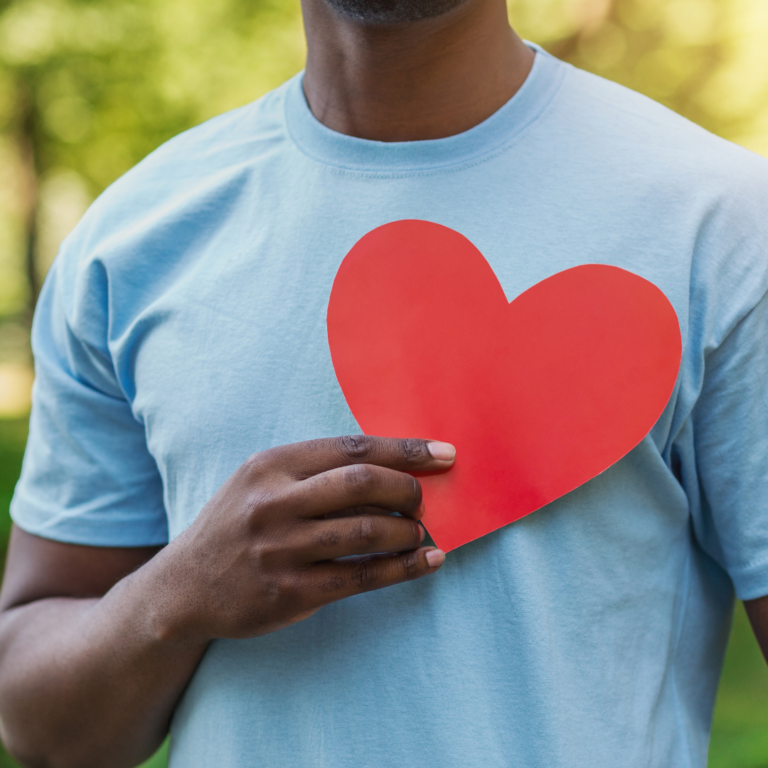 Man holding a heart symbol, representing cardiovascular health.