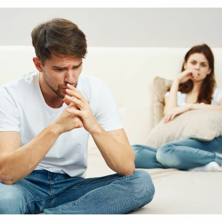 Upset man and woman on a bed, contemplating relationship issues
